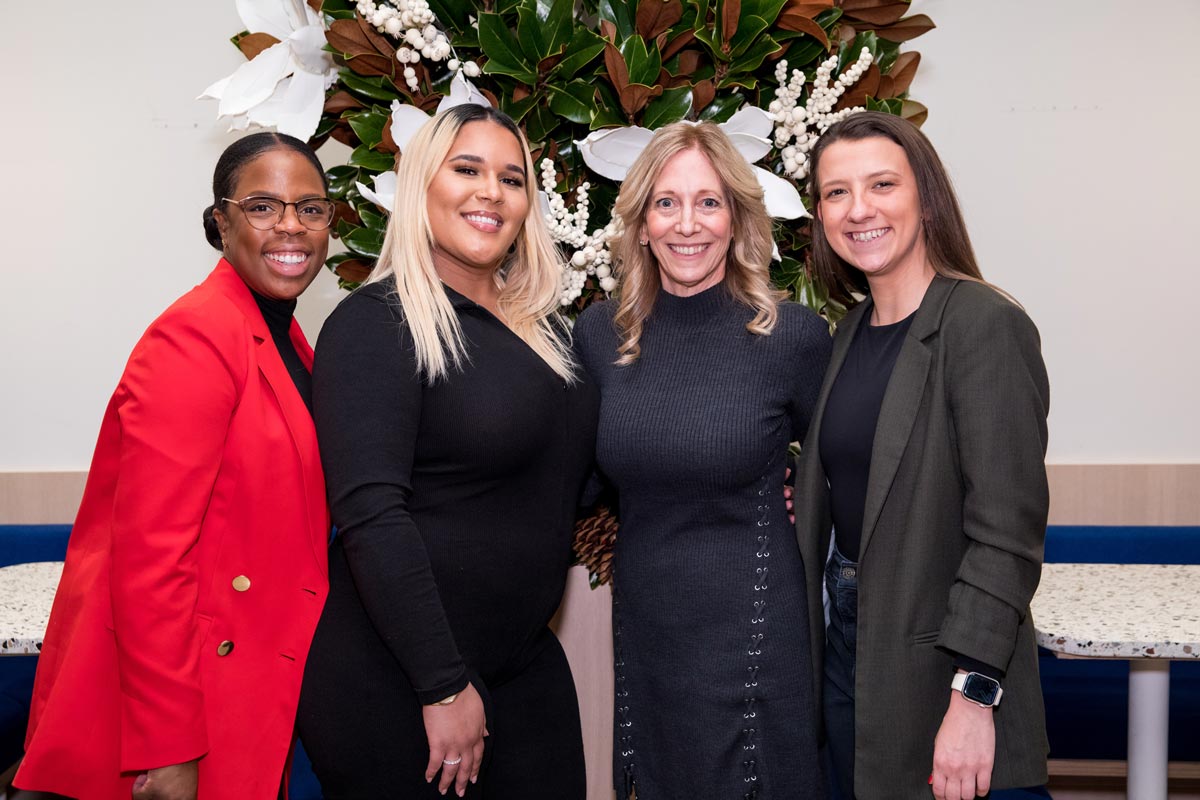 Four employees posing