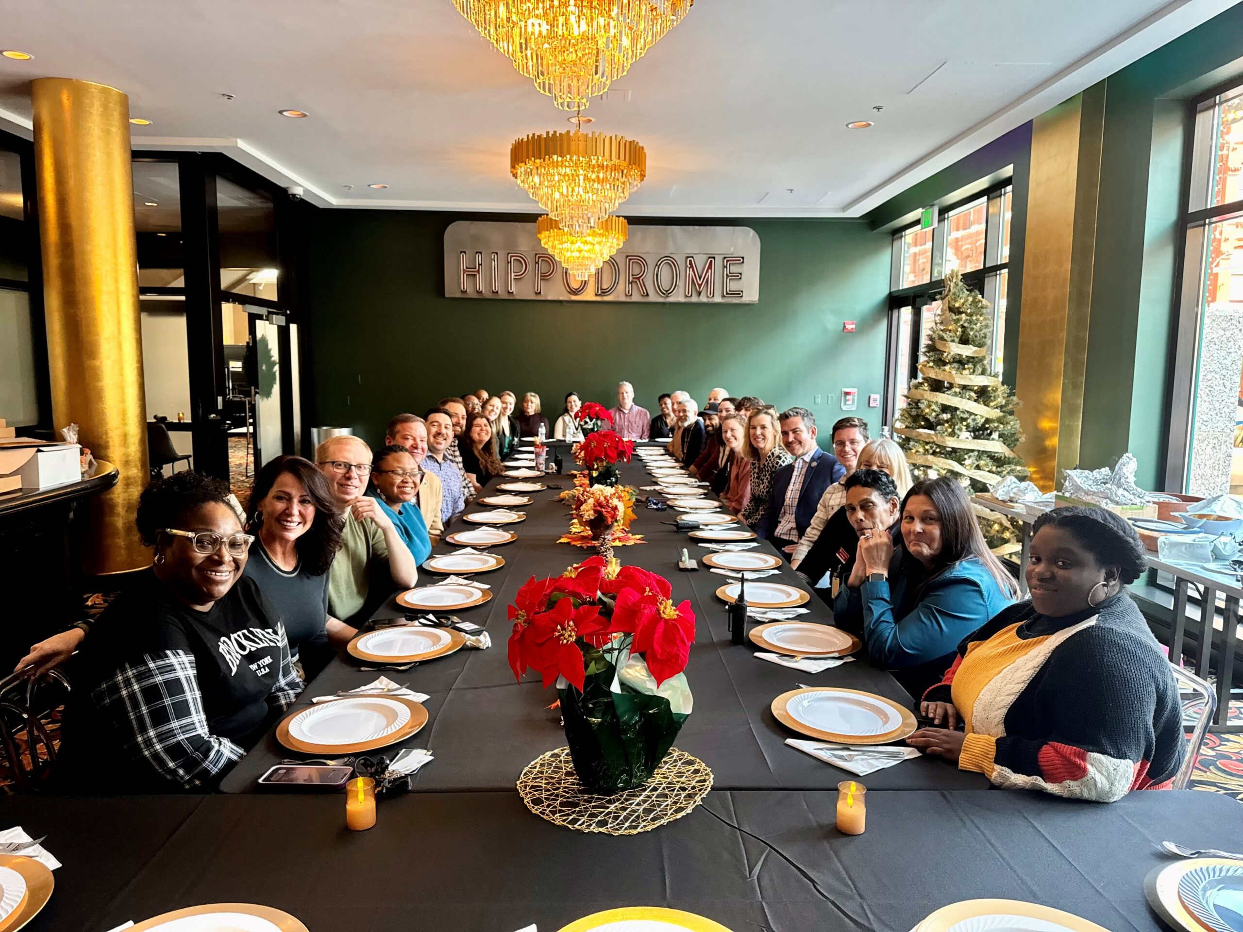 BAA's Baltimore team poses for a team photo at a long dinner table.